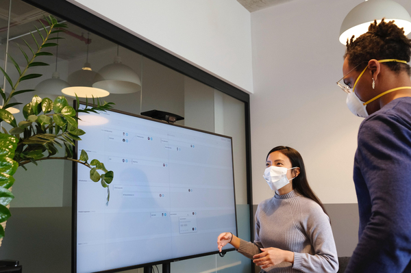 Woman in mask giving a presentation